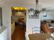 Open concept dining area with stylish chandelier looking into kitchen at 411 Vasto Dr, Venice, FL 34285