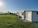 Well-spaced white home, with a manicured lawn, providing a sense of space and tranquility at 411 Vasto Dr, Venice, FL 34285