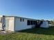 Bright, white single Gathering home, with ample room for outdoor activities on the lawn at 411 Vasto Dr, Venice, FL 34285