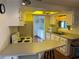 Well-lit kitchen featuring white cabinetry, laminate countertops, and updated appliances at 411 Vasto Dr, Venice, FL 34285