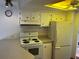 Functional kitchen with white cabinets and appliances at 411 Vasto Dr, Venice, FL 34285