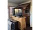 Cozy living area featuring a bamboo style cabinet and flat screen TV at 411 Vasto Dr, Venice, FL 34285