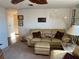 Inviting living area with plush couch, soft carpeting, and a well-lit ambiance at 411 Vasto Dr, Venice, FL 34285
