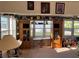 Cozy room featuring built-in shelves, natural light, and neutral carpeting at 411 Vasto Dr, Venice, FL 34285