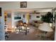 Spacious living room with plush carpeting and comfortable leather seating arrangement at 411 Vasto Dr, Venice, FL 34285