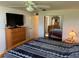 Relax in this main bedroom with a ceiling fan and easy access to the ensuite bathroom and bedroom closet at 411 Vasto Dr, Venice, FL 34285