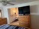 The main bedroom boasts a flatscreen television, ceiling fan, and a full ensuite bathroom with modern fixtures at 411 Vasto Dr, Venice, FL 34285