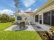 Lovely backyard patio featuring an outdoor dining set, grill, and a well-maintained lawn at 4176 Summertree Rd, Venice, FL 34293