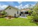 Inviting backyard patio with outdoor dining set, grill, and lush landscaping at 4176 Summertree Rd, Venice, FL 34293
