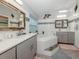Modern bathroom features double sinks, a soaking tub, and modern fixtures at 4176 Summertree Rd, Venice, FL 34293