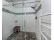 Walk-in shower features glass doors, a shower bench, and decorative tiling at 4176 Summertree Rd, Venice, FL 34293