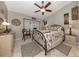 Comfortable bedroom with a decorative wrought iron bed frame, patterned rug and bright window at 4176 Summertree Rd, Venice, FL 34293