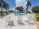 Inviting community pool area with lounge chairs and a covered pavilion, perfect for relaxation at 4176 Summertree Rd, Venice, FL 34293