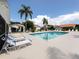 Refreshing community pool with comfortable lounge chairs and community homes in the background at 4176 Summertree Rd, Venice, FL 34293