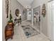 Inviting entryway with decorative mirror, table, and rug, with a view to the dining room at 4176 Summertree Rd, Venice, FL 34293