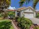 Beautiful single-story home featuring a tiled roof, a two-car garage, and a well-maintained landscaped yard at 4176 Summertree Rd, Venice, FL 34293