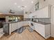 Bright kitchen featuring white cabinets, an open layout, and views to living area at 4176 Summertree Rd, Venice, FL 34293