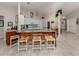 Open kitchen featuring a marble countertop island with seating, white cabinets and stainless steel appliances at 4176 Summertree Rd, Venice, FL 34293