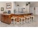 Bright kitchen with marble counters, wood accents, and seating for four at the island at 4176 Summertree Rd, Venice, FL 34293