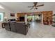 Spacious living room featuring tile flooring, a ceiling fan, and a wood-accent wall with a view to the dining room at 4176 Summertree Rd, Venice, FL 34293