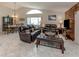 Comfortable living room with tile floors and wood accent wall with an open layout to dining room at 4176 Summertree Rd, Venice, FL 34293
