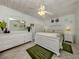 Charming main bedroom with a white ceiling fan and a lovely decorative, white, wicker-style furniture set at 4176 Summertree Rd, Venice, FL 34293