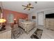Comfortable main bedroom with an accent wall, neutral furniture, and two windows at 4176 Summertree Rd, Venice, FL 34293