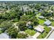 Aerial view of the property showing the neighborhood with mature trees at 4227 Blossom Rd, Venice, FL 34293