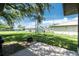 Large backyard with a concrete patio and firepit at 4227 Blossom Rd, Venice, FL 34293