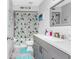 Bathroom with a vanity sink, quartz countertops, and a shower with patterned curtains at 4227 Blossom Rd, Venice, FL 34293