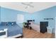 Bright bedroom featuring two beds, wood floors and a ceiling fan at 4227 Blossom Rd, Venice, FL 34293