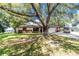 Single-story home with brick accents, a large front yard, and RV parking at 4227 Blossom Rd, Venice, FL 34293