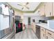 Bright kitchen with stainless steel appliances, wood cabinets and modern fixtures at 4227 Blossom Rd, Venice, FL 34293