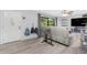 Bright living room showcasing stylish flooring and a large window overlooking the yard at 4227 Blossom Rd, Venice, FL 34293