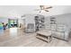 Open-concept living area with ceiling fans, hardwood floors, and a view into the dining room at 4227 Blossom Rd, Venice, FL 34293