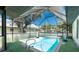 Bright screened-in pool featuring a volleyball net and turf surround at 4227 Blossom Rd, Venice, FL 34293