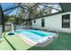 A sparkling screened-in pool with a volleyball net at 4227 Blossom Rd, Venice, FL 34293