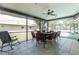 Enclosed sunroom with tile floor, outdoor view, pool access and a ceiling fan at 4227 Blossom Rd, Venice, FL 34293
