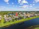 Aerial view of the house with a screened-in pool and view of community pond at 4260 Wordsworth Way, Venice, FL 34293