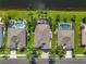 Aerial shot of residences with pools and lush landscaping with water view at 4260 Wordsworth Way, Venice, FL 34293