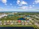 Wide aerial view of residences next to a pond. Community has screened-in pools and landscaping at 4260 Wordsworth Way, Venice, FL 34293