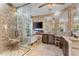 Luxurious bathroom with stone walls, walk-in shower, soaking tub, and dual vanities at 4260 Wordsworth Way, Venice, FL 34293