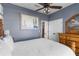 Comfortable bedroom boasts a ceiling fan, closet space, and a framed painting above the bed at 4260 Wordsworth Way, Venice, FL 34293