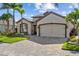 Beautiful single-story home with a paver driveway, two-car garage, and manicured landscaping at 4260 Wordsworth Way, Venice, FL 34293