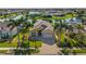 Beautiful waterfront home with lush landscaping, brick driveway and palm trees, creating a tropical paradise at 4260 Wordsworth Way, Venice, FL 34293