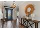 Inviting foyer with a decorative mirror, stylish console table, and a glimpse of the interior at 4260 Wordsworth Way, Venice, FL 34293