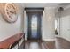 Elegant foyer features a decorative front door, console table, and wood-look flooring at 4260 Wordsworth Way, Venice, FL 34293