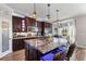 Kitchen with dark cabinetry, granite counters, pendant lighting, and a breakfast nook at 4260 Wordsworth Way, Venice, FL 34293