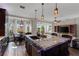 Open kitchen island featuring stainless steel sink and appliances that overlooks the living room at 4260 Wordsworth Way, Venice, FL 34293