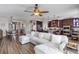 Open floor plan with a spacious living room and kitchen featuring dark wood cabinets and modern appliances at 4260 Wordsworth Way, Venice, FL 34293